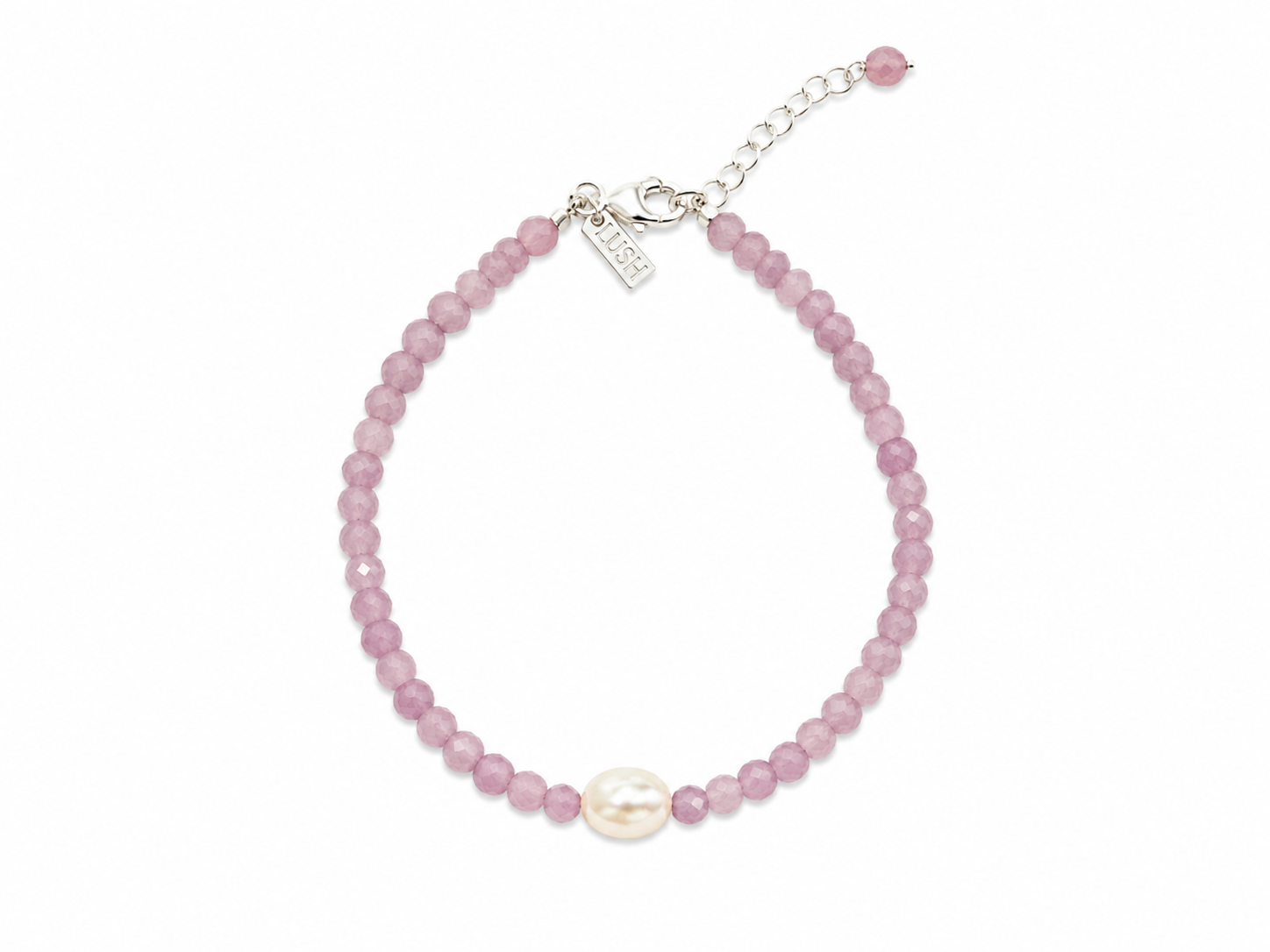 Pink pearl gemstone bracelet with faceted blush beads, genuine freshwater pearl, sterling silver adjustable chain, and LUSH tag worn on a sun-kissed wrist by the ocean.